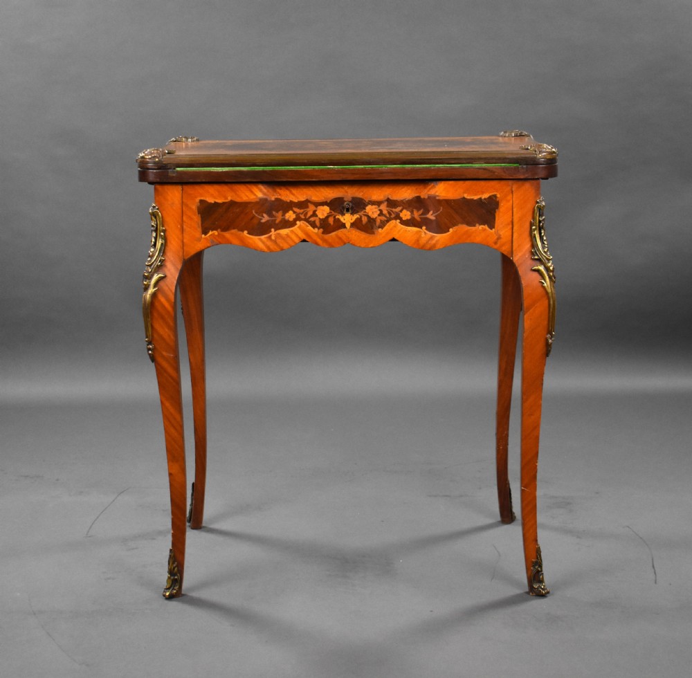 A Victorian French-style marquetry card table featuring slender cabriole legs with brass mounts and intricate floral inlay along the serpentine apron. View III