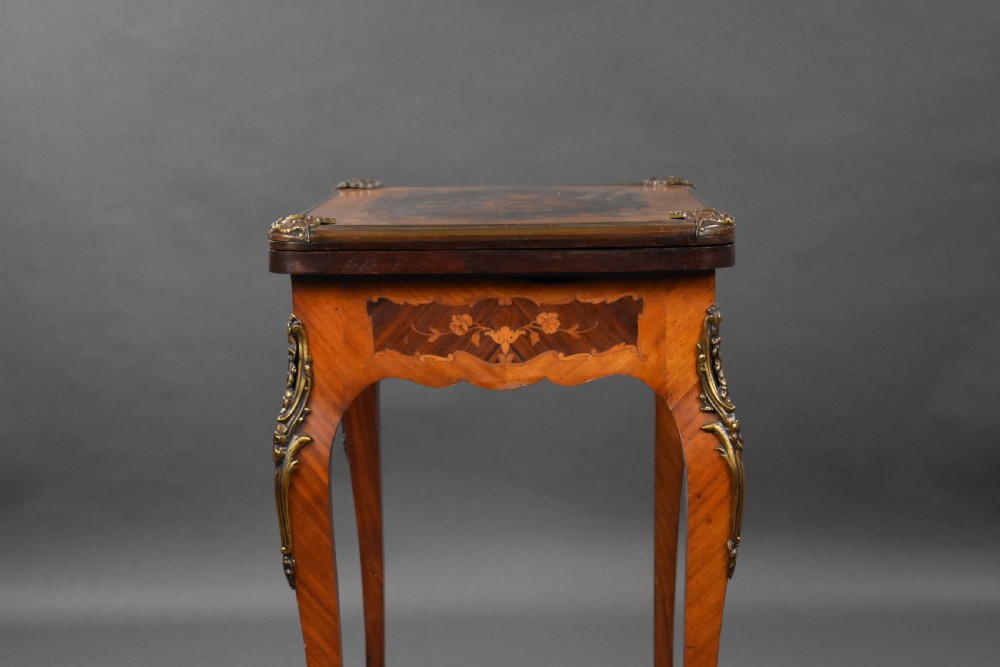 A Victorian French-style marquetry card table featuring slender cabriole legs with brass mounts and intricate floral inlay along the serpentine apron. View XI