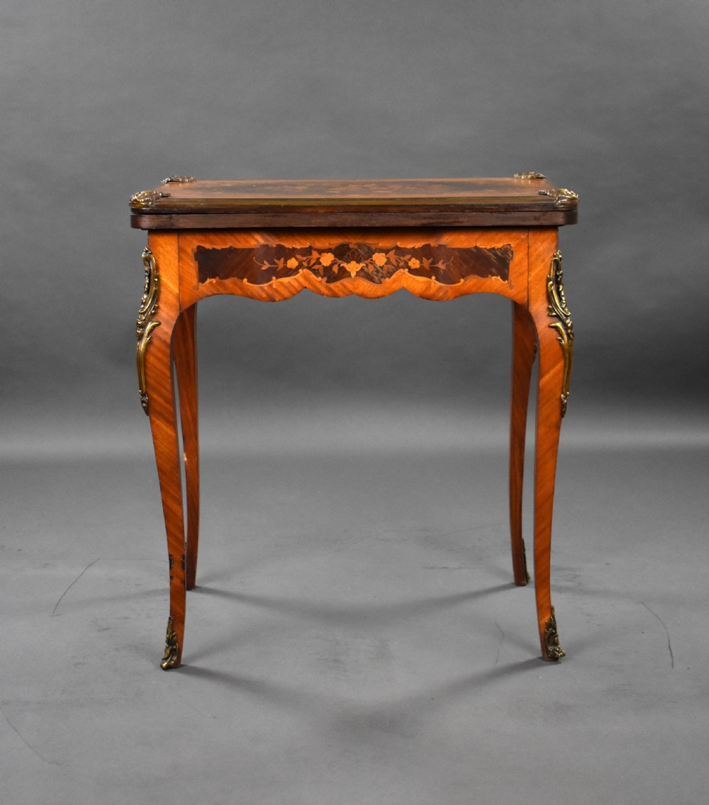 A Victorian French-style marquetry card table featuring slender cabriole legs with brass mounts and intricate floral inlay along the serpentine apron. View XII
