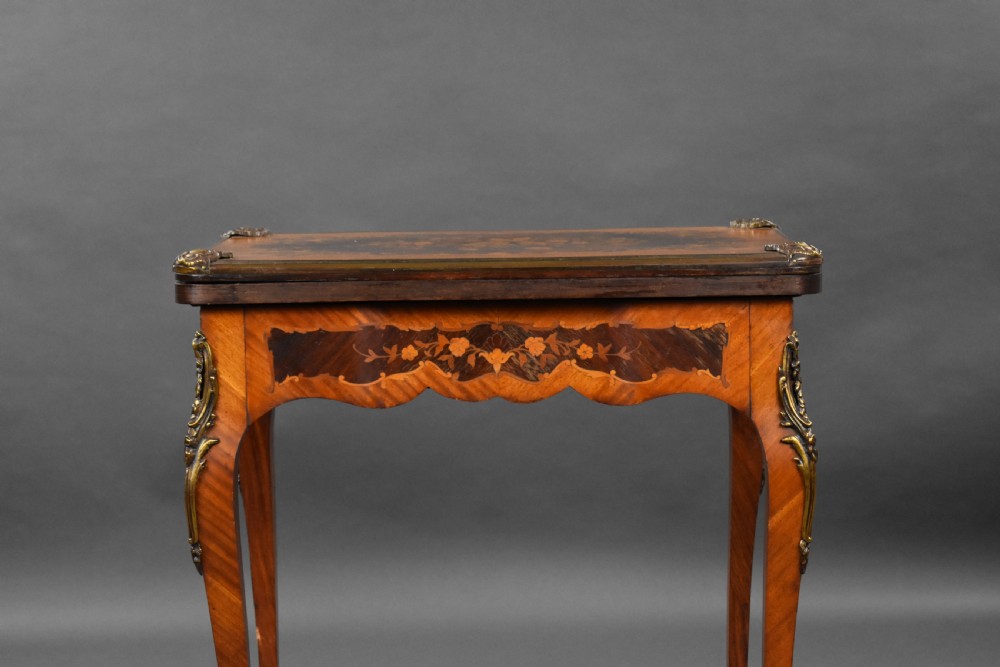 A Victorian French-style marquetry card table featuring slender cabriole legs with brass mounts and intricate floral inlay along the serpentine apron. View XIII