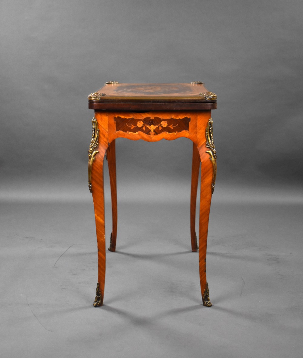 A Victorian French-style marquetry card table featuring slender cabriole legs with brass mounts and intricate floral inlay along the serpentine apron. View XIV