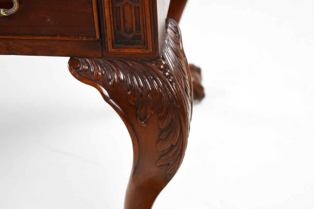 A dark brown mahogany Chippendale style writing table featuring cabriole legs with claw and ball feet, carved knees, gadrooned edging, and drawers with brass swan-neck handles. View VI