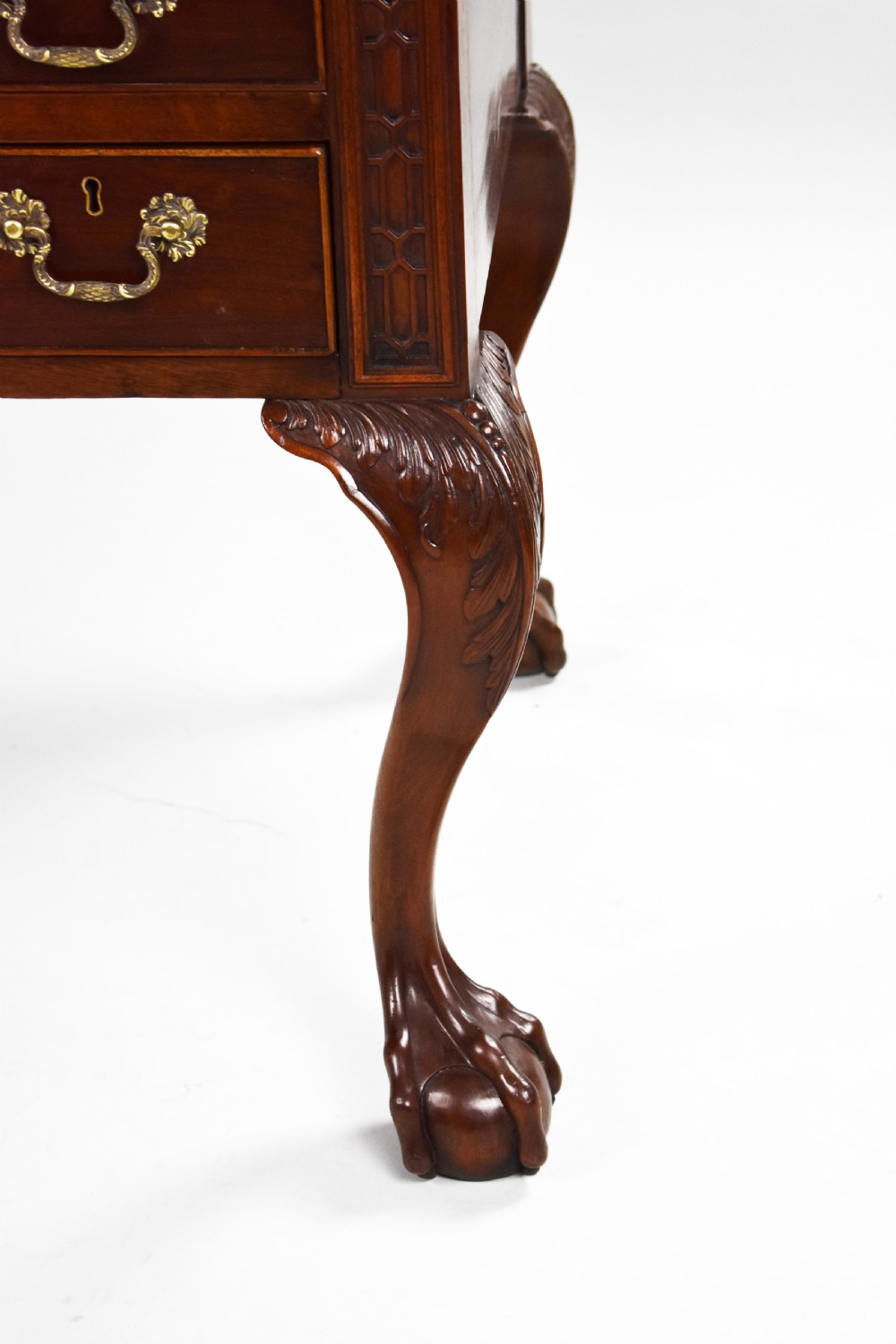A dark brown mahogany Chippendale style writing table featuring cabriole legs with claw and ball feet, carved knees, gadrooned edging, and drawers with brass swan-neck handles. View VII