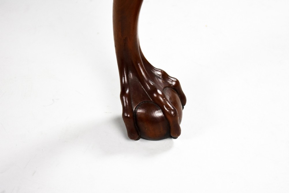 A dark brown mahogany Chippendale style writing table featuring cabriole legs with claw and ball feet, carved knees, gadrooned edging, and drawers with brass swan-neck handles. View VIII