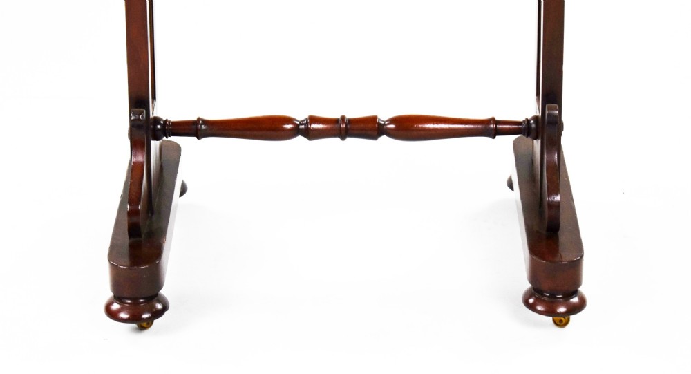 A Victorian mahogany work table featuring a single drawer with wooden knobs, a suspended yellow patterned fabric basket below, and a turned stretcher base set on castors. View IV