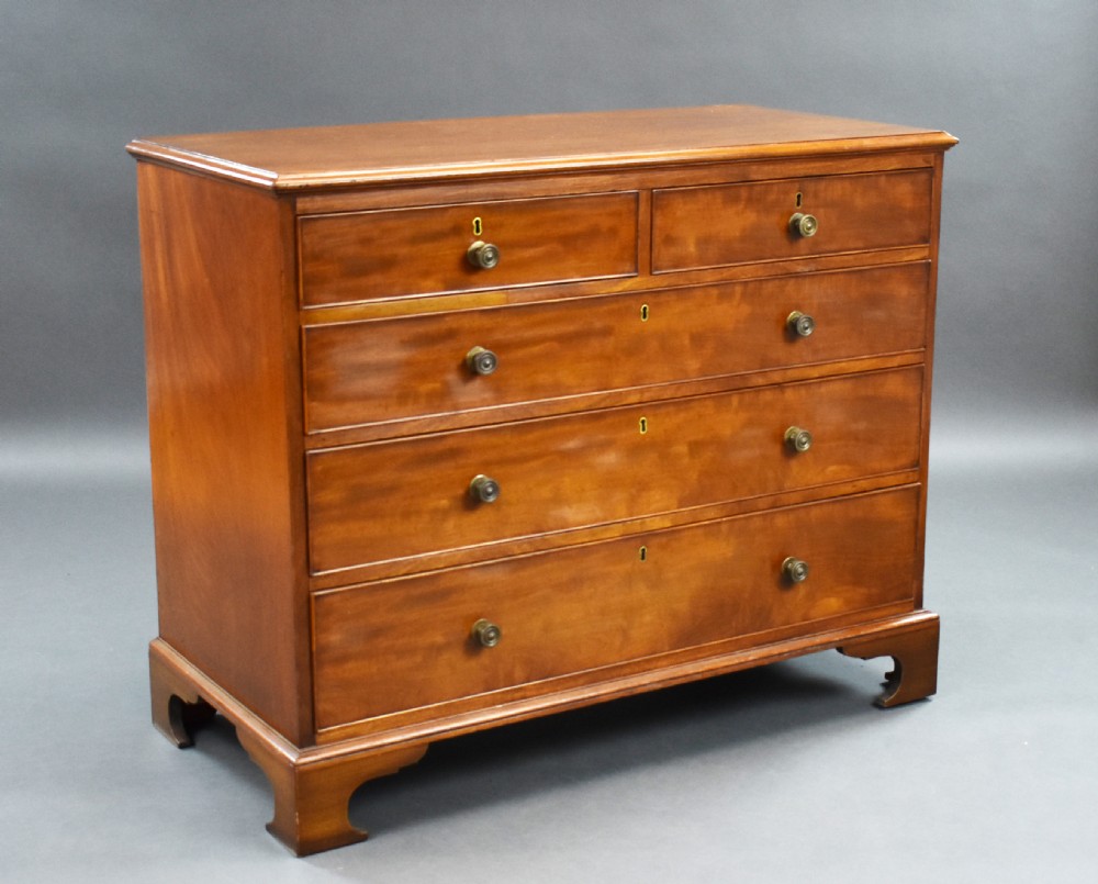 A George III mahogany chest of drawers featuring two short over three long graduated drawers resting on classic bracket feet.