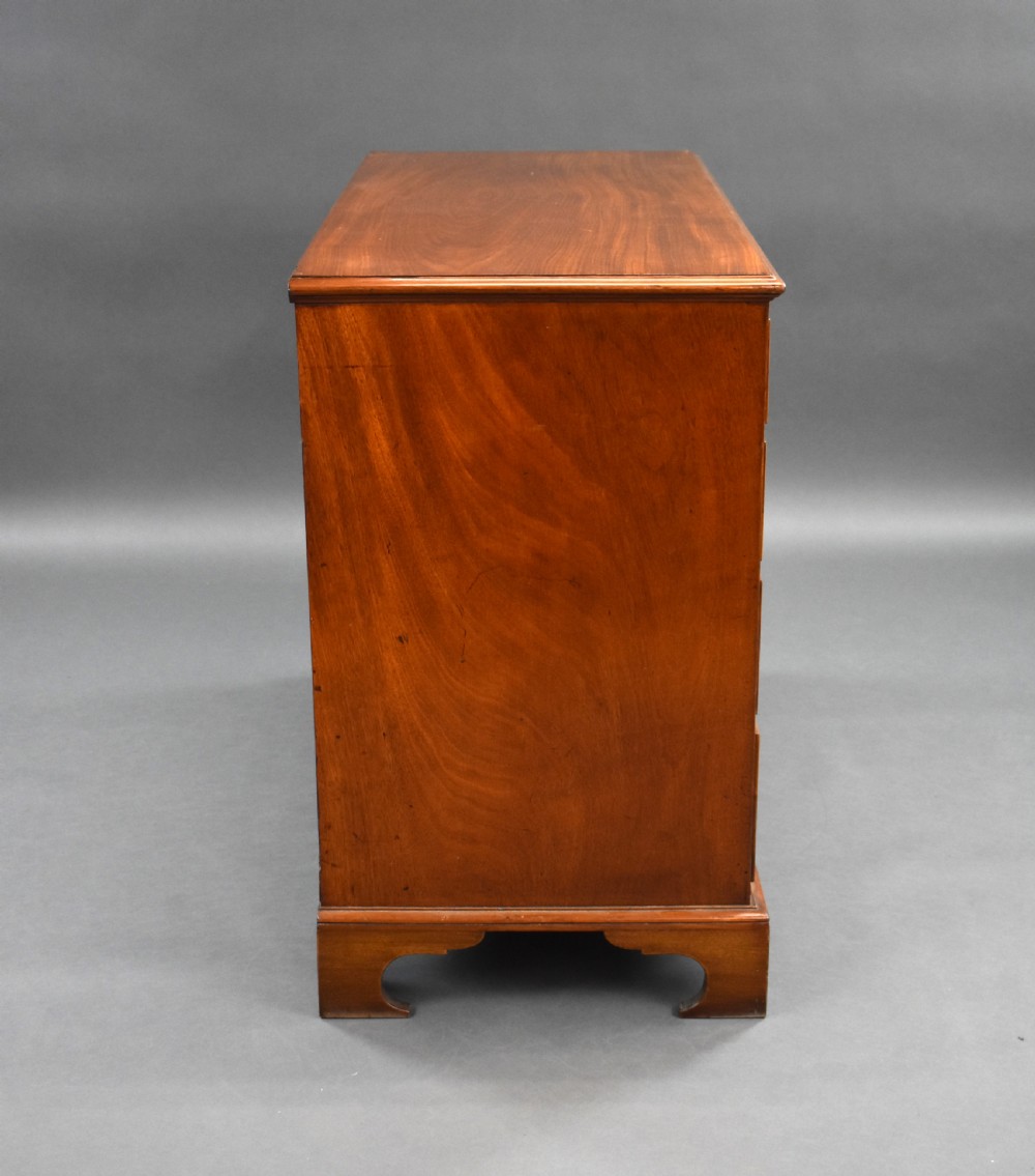 A George III mahogany chest of drawers featuring two short over three long graduated drawers resting on classic bracket feet. View III