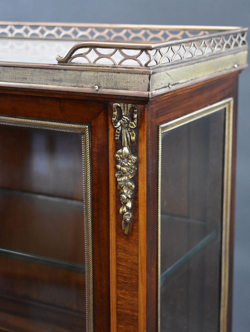 A 19th-century French walnut cabinet featuring a two-door glazed top display section above a lower storage unit with drawers and brass mounts, raised on tapered legs. View VII