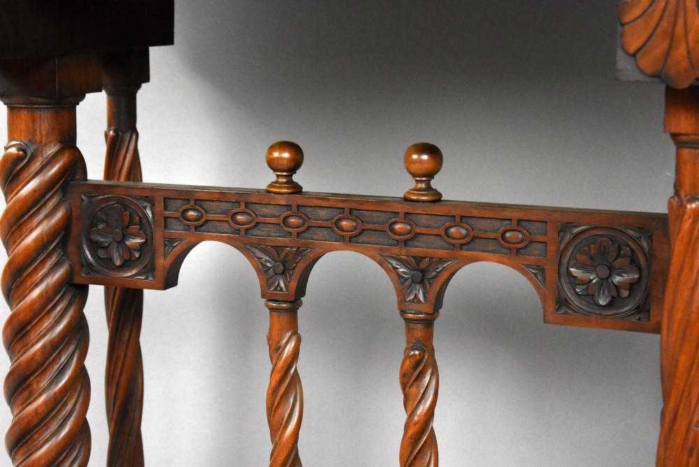 A 17th-century Spanish walnut Bargueno cabinet featuring an intricate brass lockplate and side mounts, resting on an ornate barley-twist wooden stand. View IX