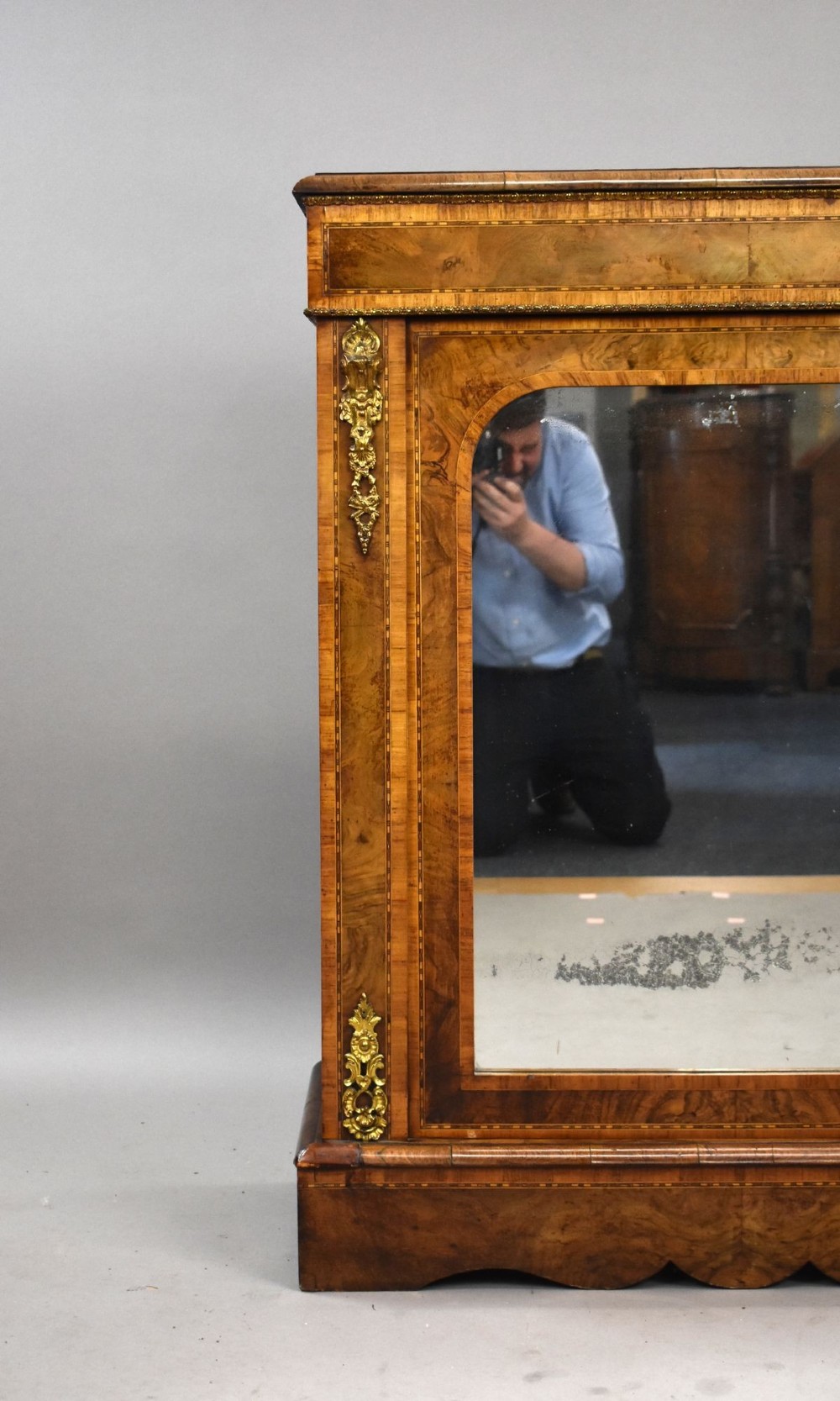 A Victorian burr walnut pier cabinet featuring a single glazed door, boxwood marquetry stringing, and ornate gilt brass mounts. View VII