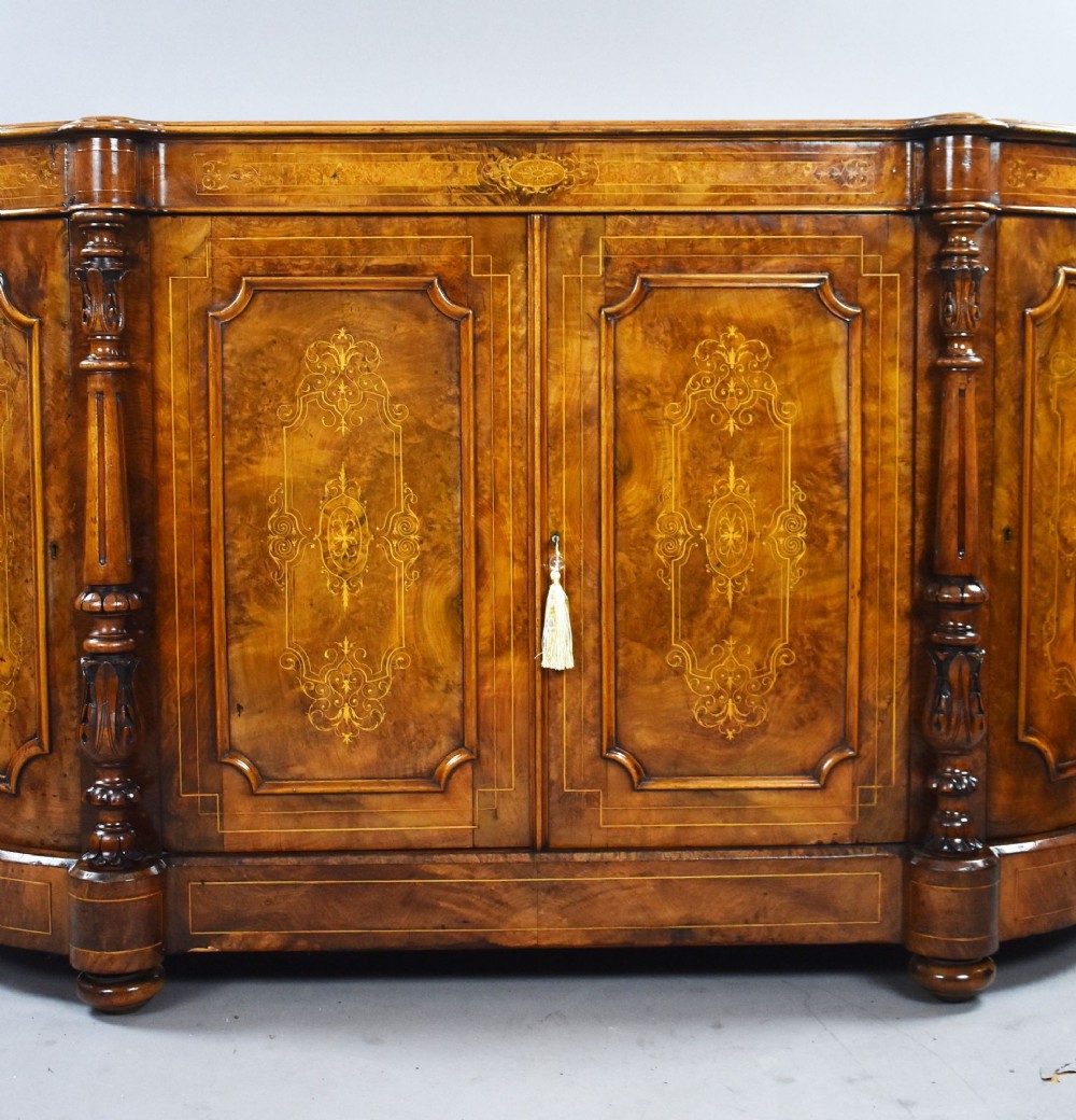 A Victorian burr walnut credenza featuring elaborate floral marquetry inlays on two central doors, flanked by turned columns and rounded side panels. View III