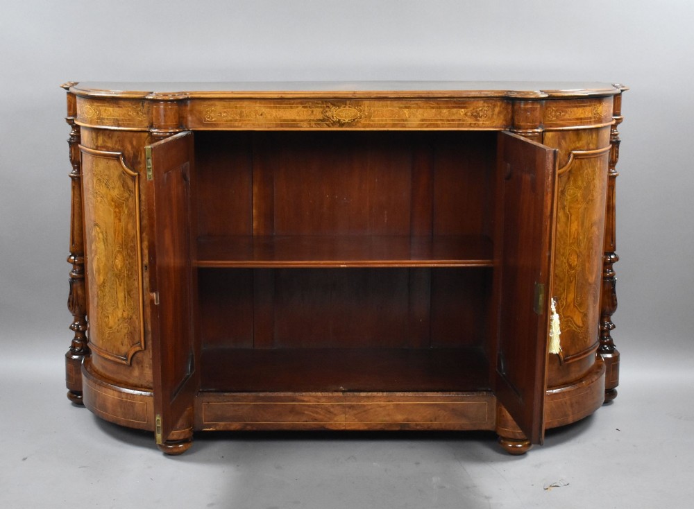 A Victorian burr walnut credenza featuring elaborate floral marquetry inlays on two central doors, flanked by turned columns and rounded side panels. View VIII