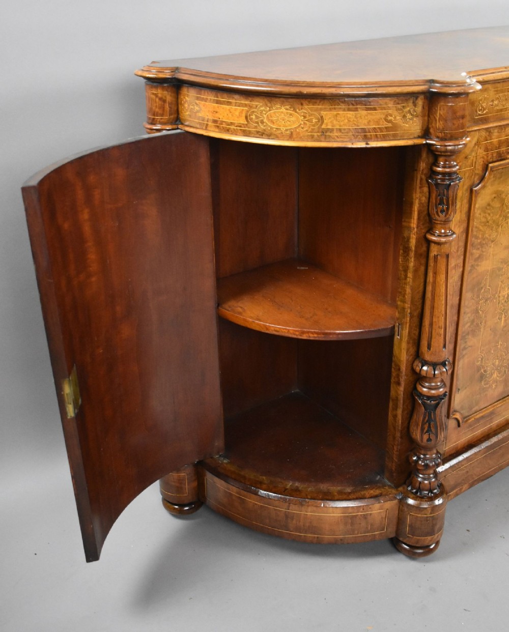 A Victorian burr walnut credenza featuring elaborate floral marquetry inlays on two central doors, flanked by turned columns and rounded side panels. View IX
