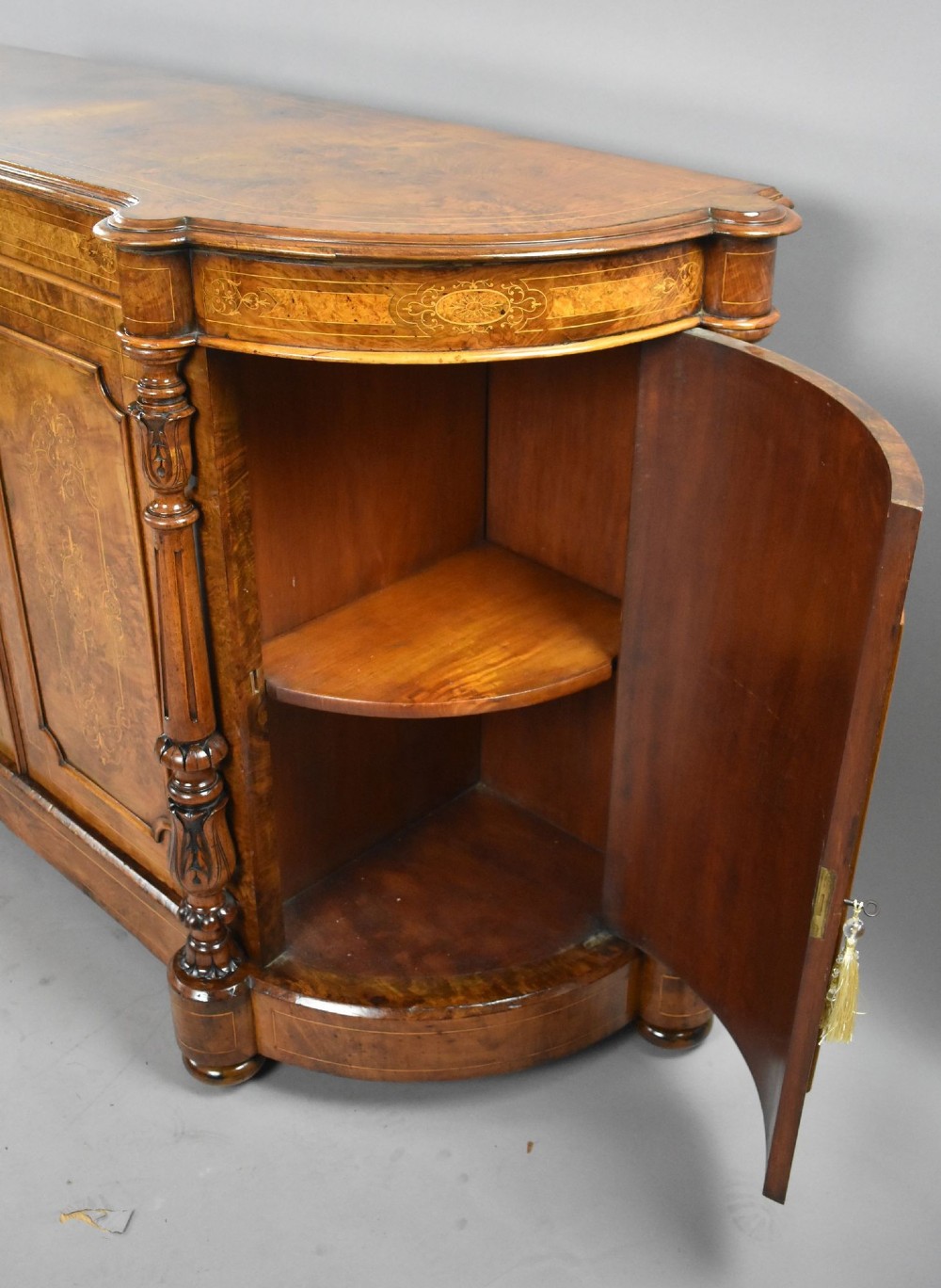 A Victorian burr walnut credenza featuring elaborate floral marquetry inlays on two central doors, flanked by turned columns and rounded side panels. View X