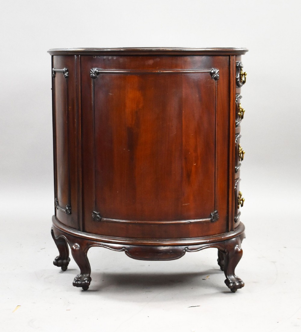 A dark mahogany kidney-shaped writing desk with a gilded leather top insert, twin pedestals featuring ornate brass handles, and cabriole legs ending in claw-and-ball feet. View IV