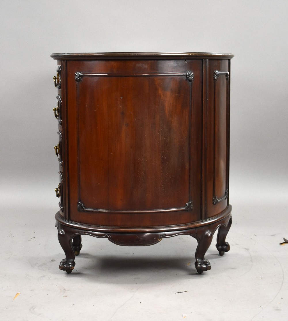 A dark mahogany kidney-shaped writing desk with a gilded leather top insert, twin pedestals featuring ornate brass handles, and cabriole legs ending in claw-and-ball feet. View XI