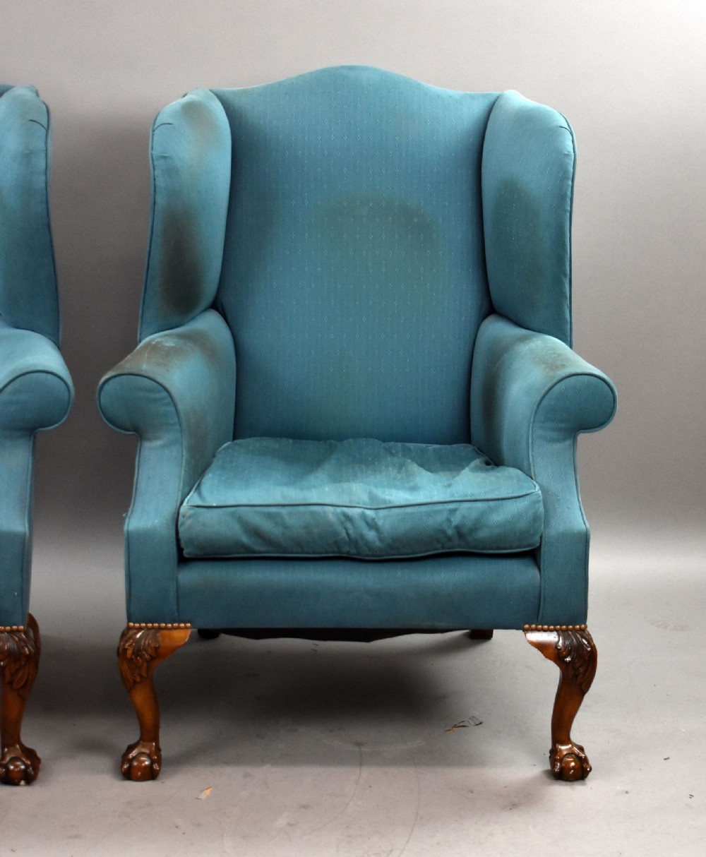 A pair of antique wingback armchairs upholstered in teal blue fabric with carved mahogany cabriole legs and claw-and-ball feet. View IV