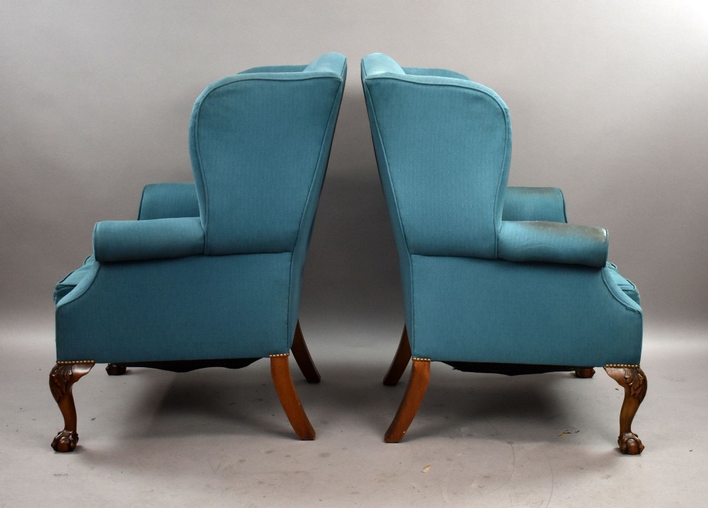 A pair of antique wingback armchairs upholstered in teal blue fabric with carved mahogany cabriole legs and claw-and-ball feet. View VI