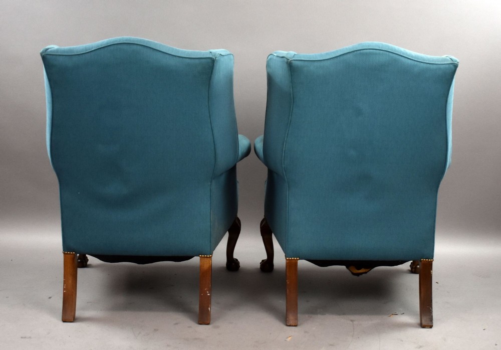 A pair of antique wingback armchairs upholstered in teal blue fabric with carved mahogany cabriole legs and claw-and-ball feet. View VII