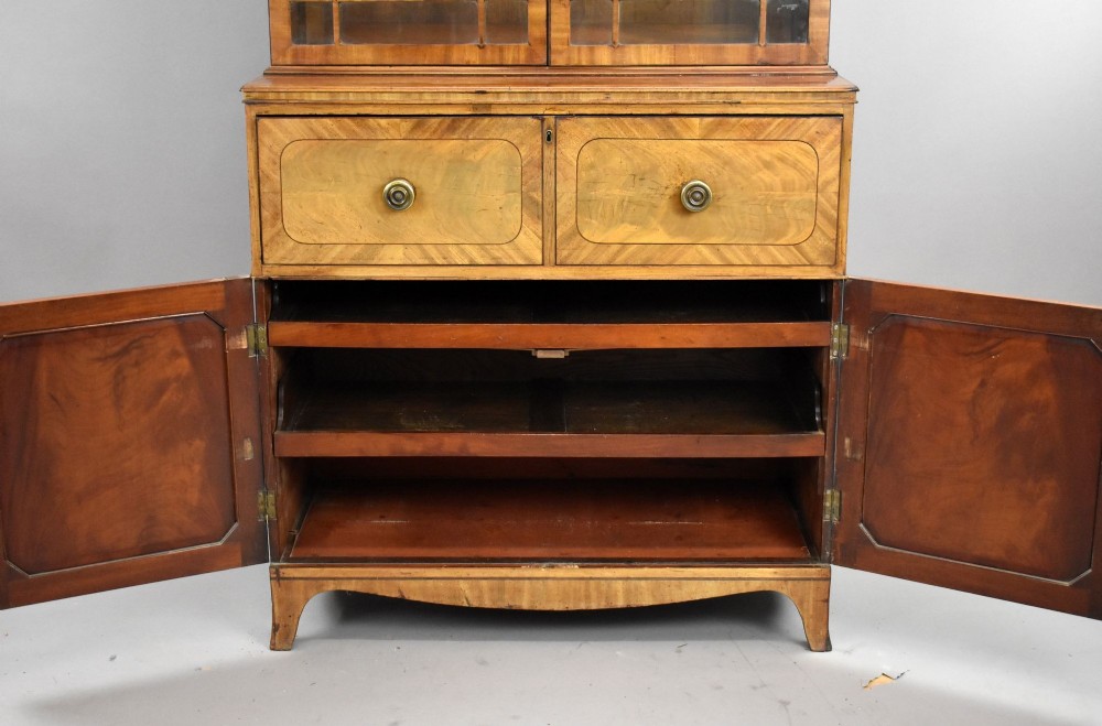 An antique mahogany secretaire bookcase featuring a glazed upper display cabinet with diamond astragal glazing bars above a lower chest and double cupboard base. View VIII