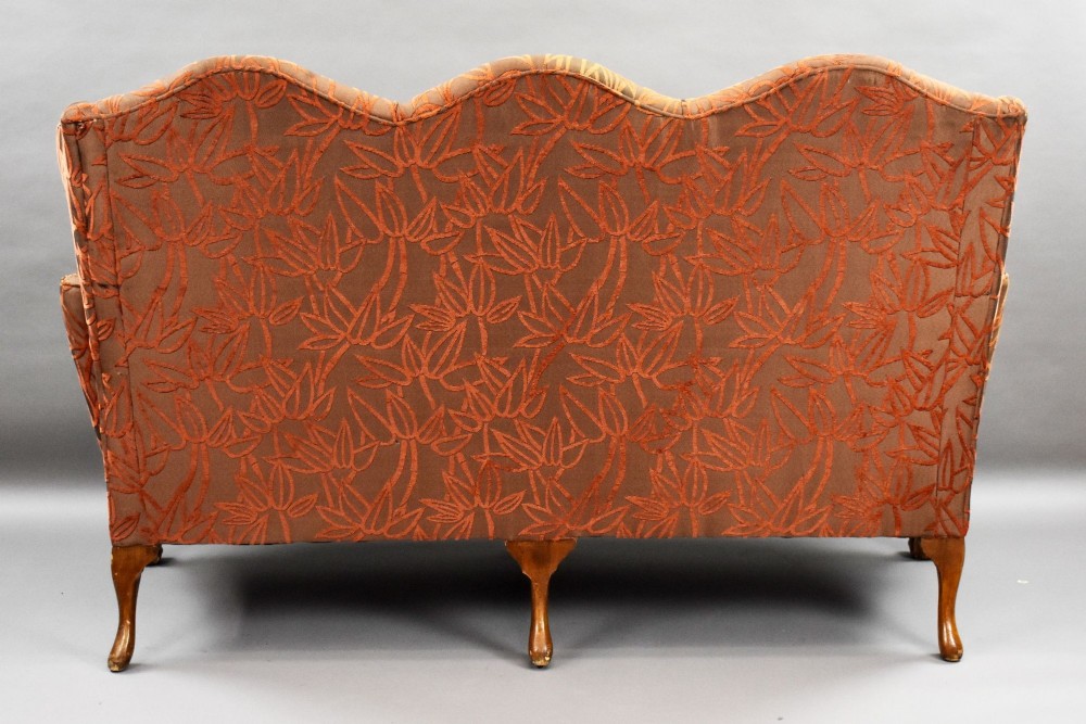 A Queen Anne style three-seat sofa featuring terracotta leaf-patterned upholstery, a triple-arched backrest, and carved walnut cabriole legs with ball-and-claw feet. View V
