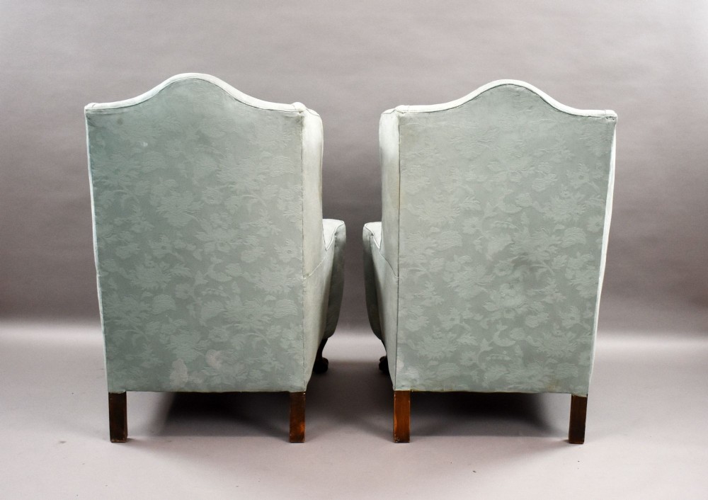 A pair of antique wingback armchairs upholstered in duck egg blue damask fabric with carved cabriole legs and ball-and-claw feet. View VI