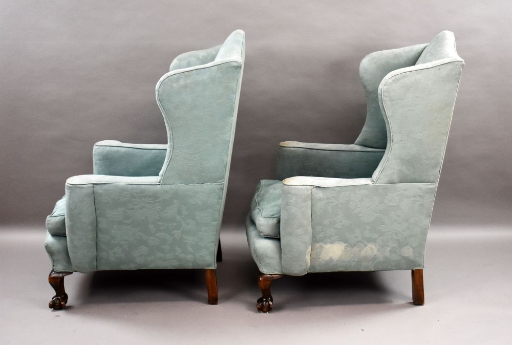 A pair of antique wingback armchairs upholstered in duck egg blue damask fabric with carved cabriole legs and ball-and-claw feet. View VII