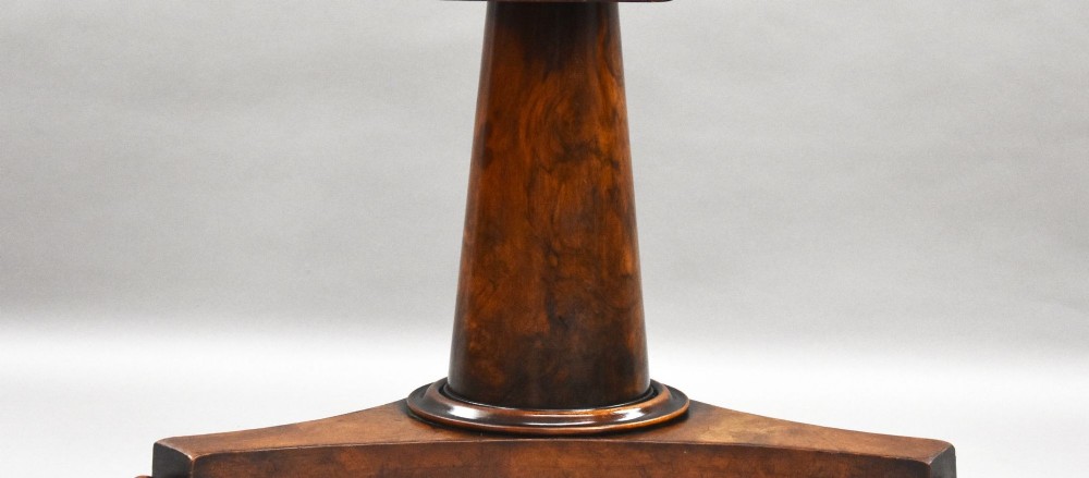 A circular Regency breakfast table with a figured burr elm veneered top displayed upright on a wooden pedestal base. View IV