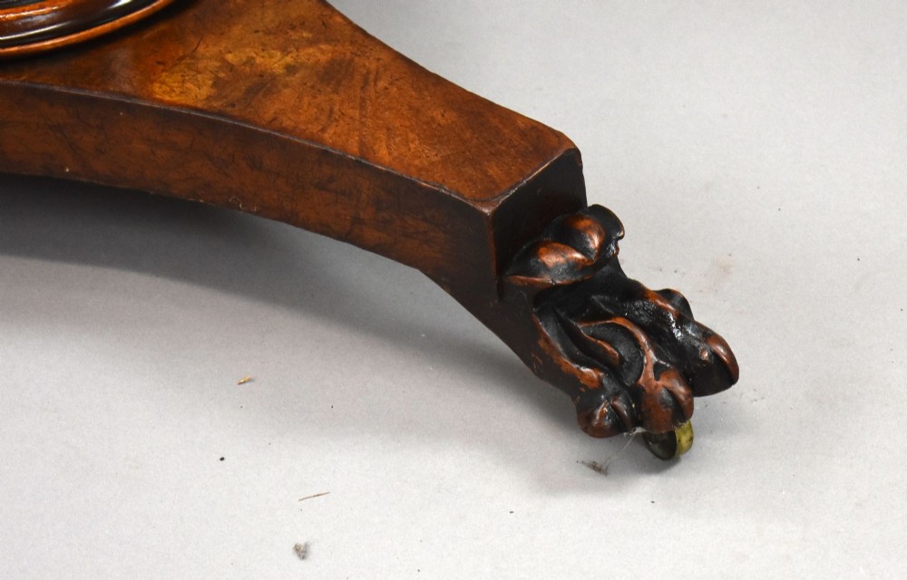 A circular Regency breakfast table with a figured burr elm veneered top displayed upright on a wooden pedestal base. View VI