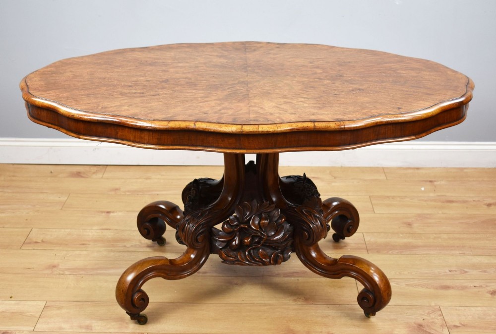A Victorian tilt-top loo table shown vertically, featuring quarter-matched burr walnut veneer with a scalloped edge on carved cabriole legs. View II
