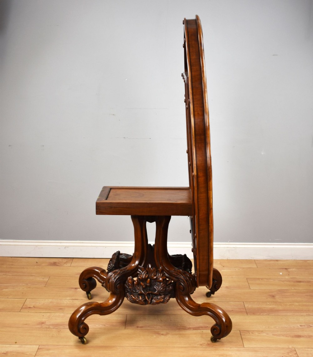 A Victorian tilt-top loo table shown vertically, featuring quarter-matched burr walnut veneer with a scalloped edge on carved cabriole legs. View V