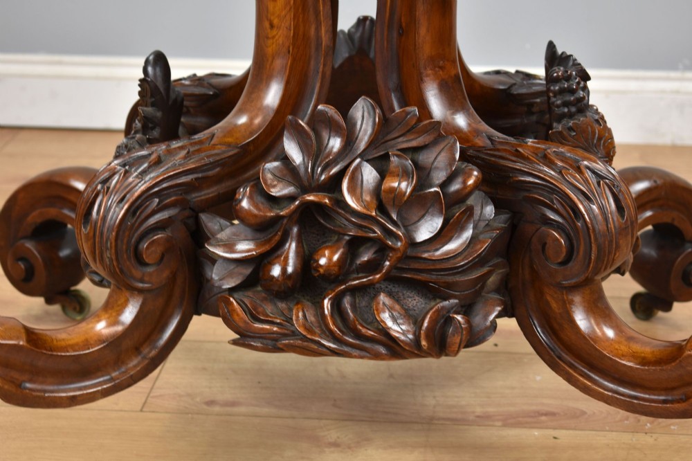 A Victorian tilt-top loo table shown vertically, featuring quarter-matched burr walnut veneer with a scalloped edge on carved cabriole legs. View VII