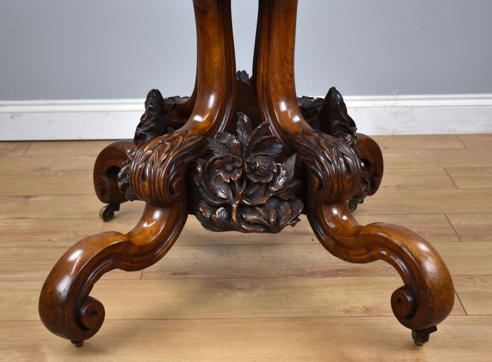 A Victorian tilt-top loo table shown vertically, featuring quarter-matched burr walnut veneer with a scalloped edge on carved cabriole legs. View XIII