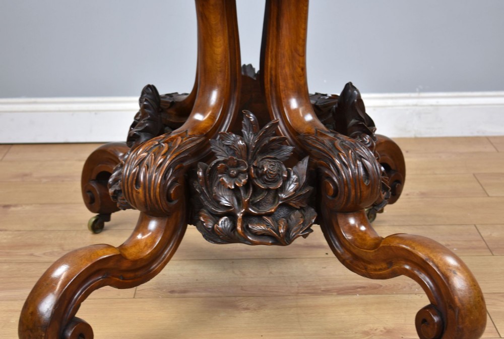 A Victorian tilt-top loo table shown vertically, featuring quarter-matched burr walnut veneer with a scalloped edge on carved cabriole legs. View XIV