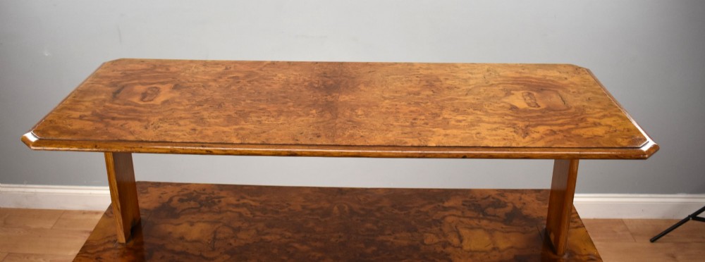 A Victorian burr walnut three-tier telescopic dumbwaiter featuring adjustable shelves resting on carved trestle supports. View VI