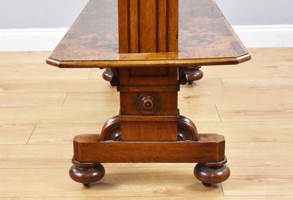 A Victorian burr walnut three-tier telescopic dumbwaiter featuring adjustable shelves resting on carved trestle supports. View IX