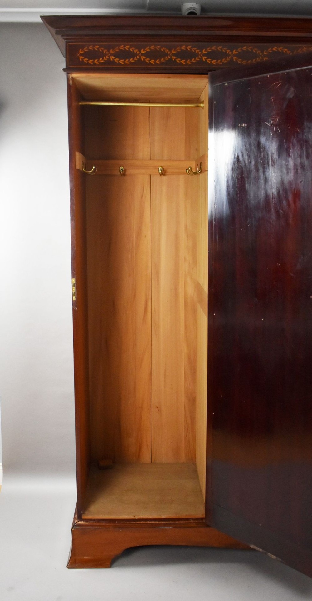 An Edwardian mahogany triple wardrobe featuring twin full-length mirror doors flanking a central inlaid cupboard and four drawers. View VI