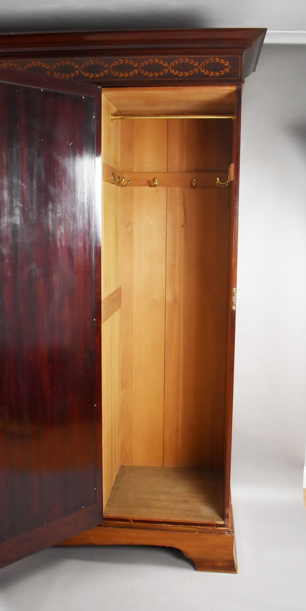 An Edwardian mahogany triple wardrobe featuring twin full-length mirror doors flanking a central inlaid cupboard and four drawers. View VIII