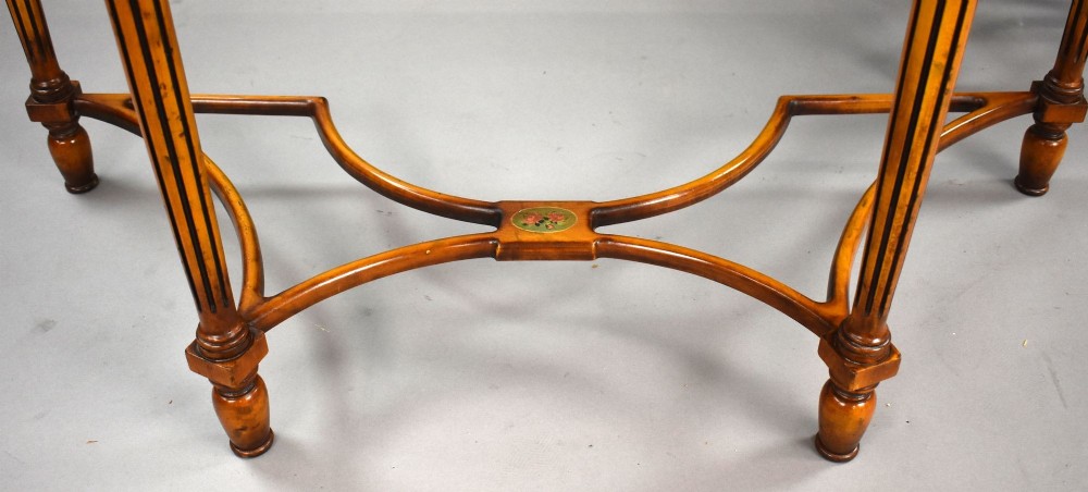 A pair of Sheraton Revival demi-lune console tables in golden satinwood with hand-painted floral garlands, fluted tapered legs, and decorative stretchers. View IV