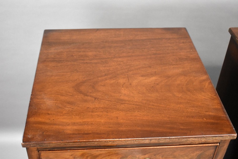 A matching pair of tall, narrow mahogany bedside chests, each featuring five drawers with brass handles and resting on bracket feet. View VIII