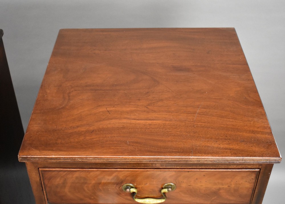 A matching pair of tall, narrow mahogany bedside chests, each featuring five drawers with brass handles and resting on bracket feet. View IX
