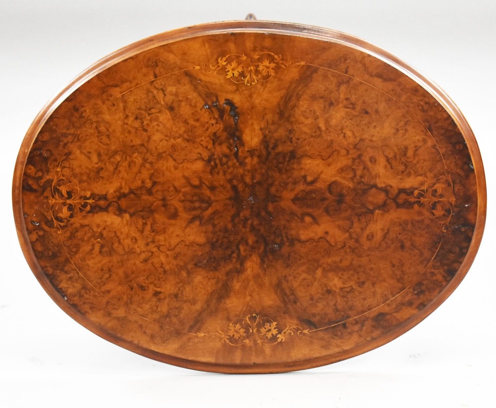 A Victorian burr walnut occasional table featuring a figure-patterned top, a barley twist carved stem, and a carved tripod base. View VI