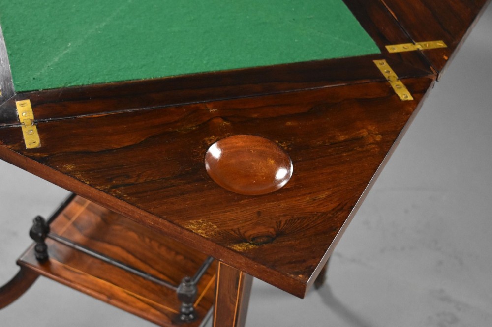An Edwardian inlaid rosewood envelope card table with tapered square legs, brass castors, a lower undertier shelf, and a top split into four triangular leaves. View VIII