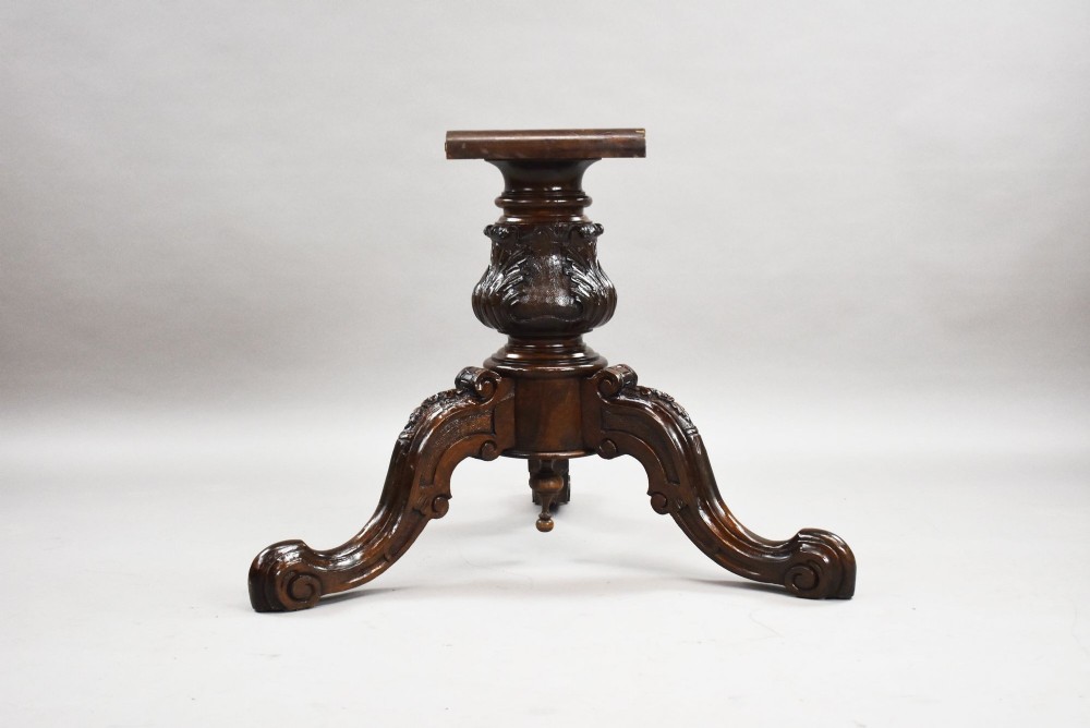 A Victorian circular burr walnut centre table featuring floral marquetry inlays on the tabletop and a dark carved pedestal base. View V