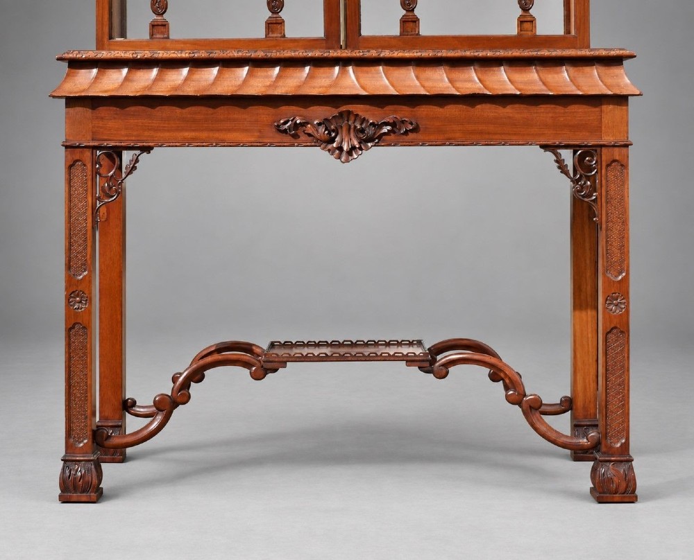 A late Victorian mahogany display cabinet in the Chinese Chippendale style with a pierced cresting, glazed tracery doors, and carved legs with an under-tier. View V