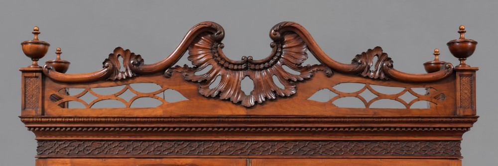 A late Victorian mahogany display cabinet in the Chinese Chippendale style with a pierced cresting, glazed tracery doors, and carved legs with an under-tier. View VIII