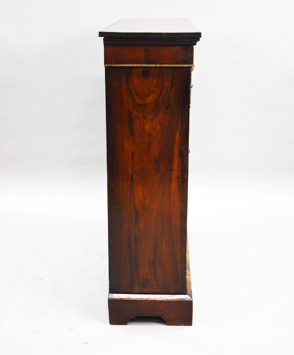 A Victorian mahogany pier cabinet featuring two glazed doors, floral marquetry inlay, gilt-bronze mounts, and a fabric-lined interior with shelves. View V