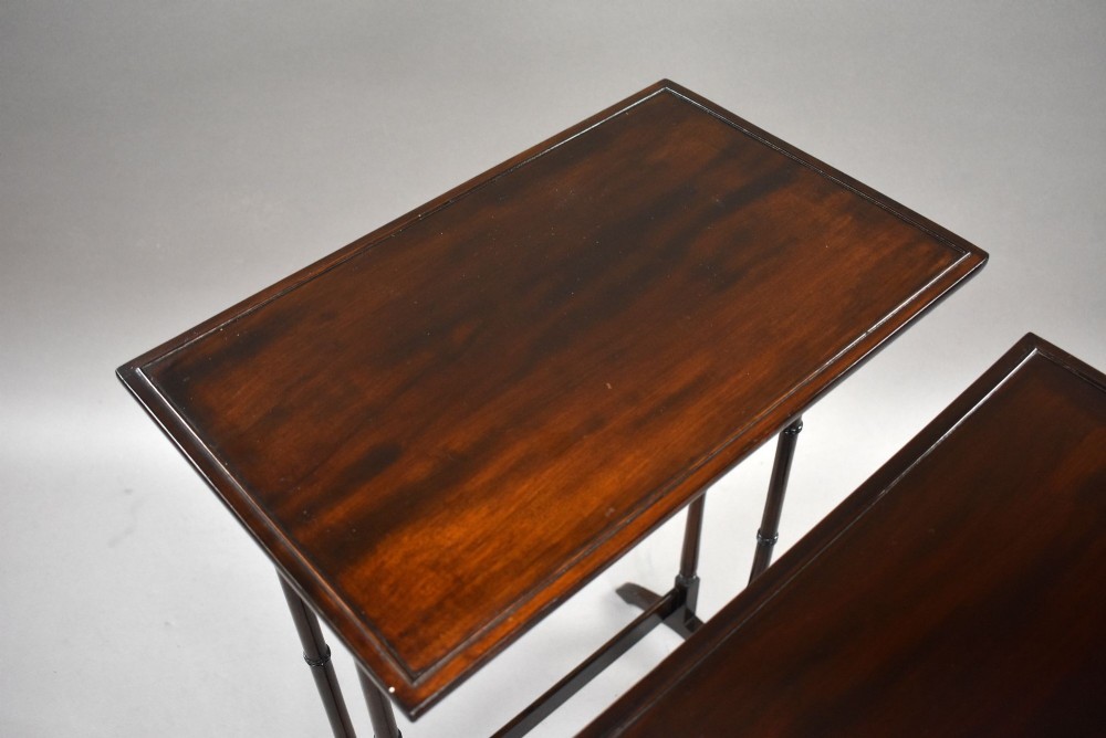 An Edwardian nest of three graduating mahogany tables with turned legs and trestle feet. View V