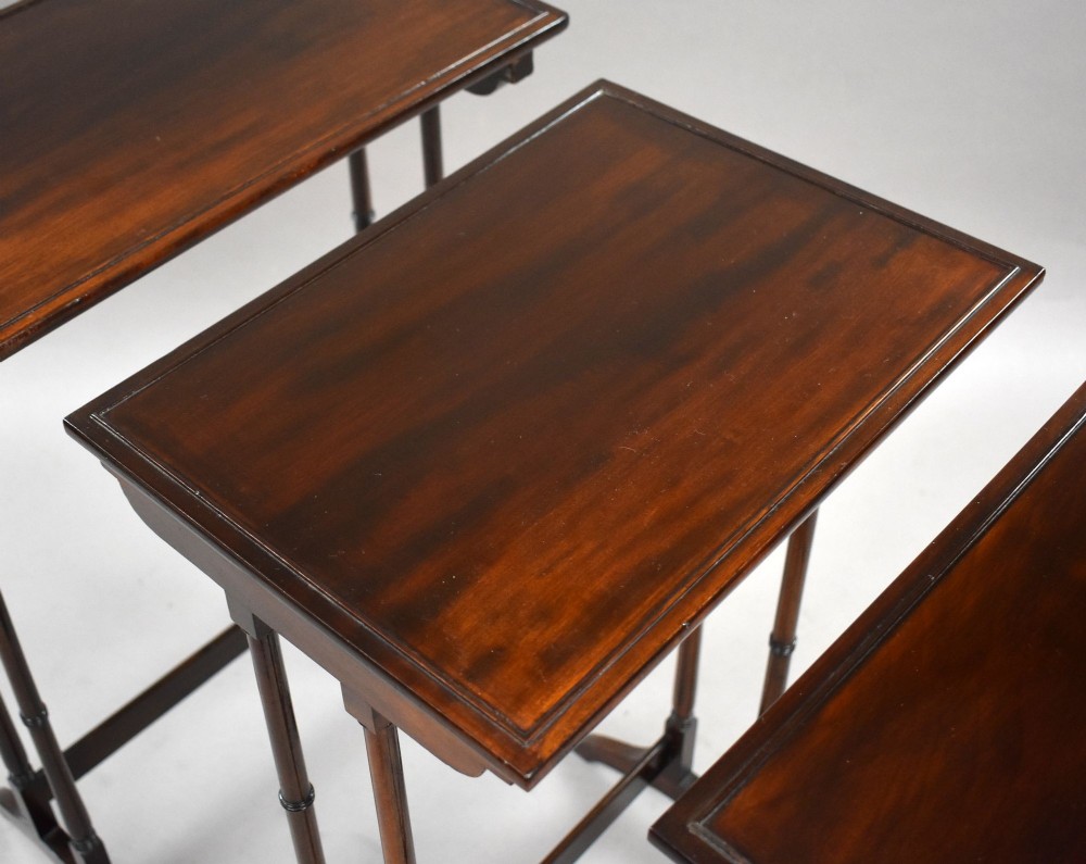 An Edwardian nest of three graduating mahogany tables with turned legs and trestle feet. View VI