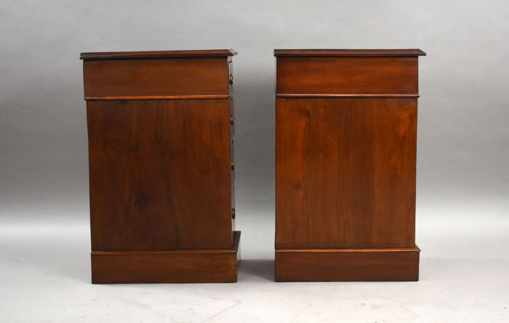 A matching pair of narrow Victorian mahogany bedside chests, each featuring four stacked drawers with central brass ring pulls set on a solid plinth base. View III